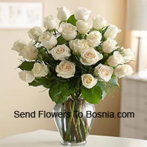 24 White Roses With Some Ferns In A Glass Vase