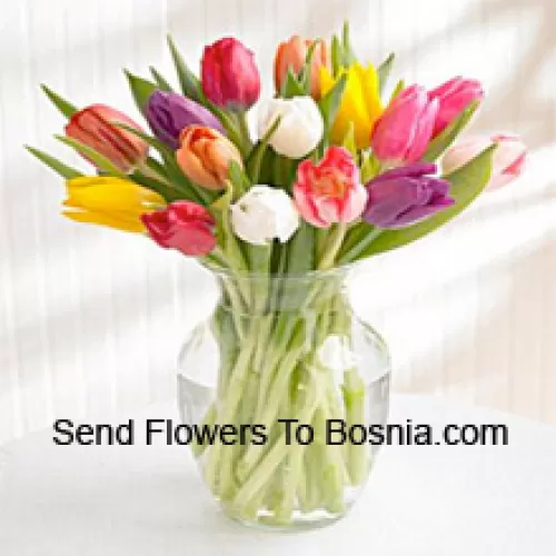 Mixed Colored Tulips In A Glass Vase - Please Note That In Case Of Non-Availability Of Certain Seasonal Flowers The Same Will Be Substituted With Other Flowers Of Same Value